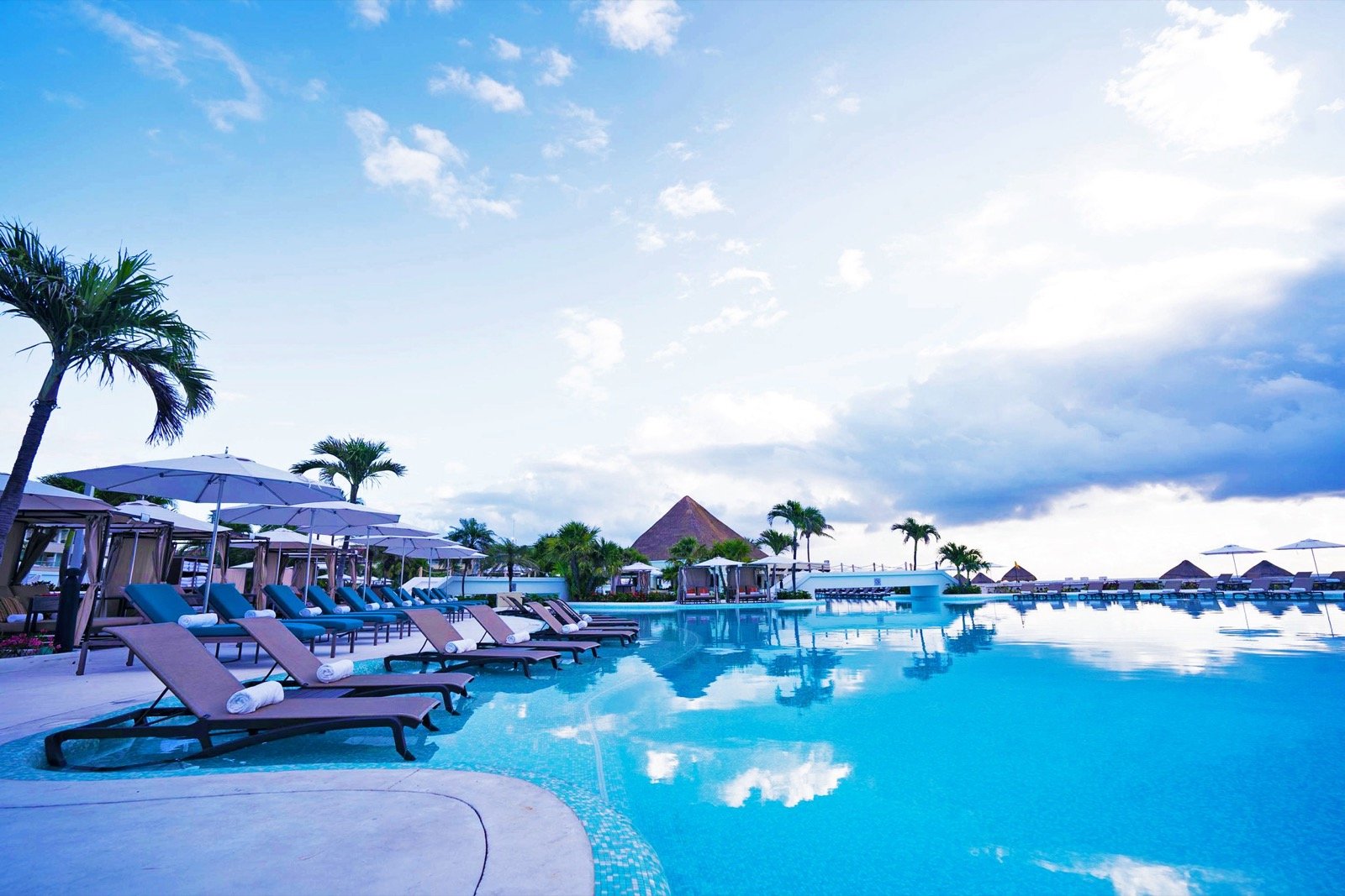 Moon Palace Cancun pool with loungers and ocean view